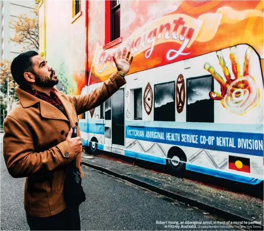  ?? (Asanka Brendon Ratnayake/The New York Times) ?? Robert Young, an Aboriginal artist, in front of a mural he painted in Fitzroy, Australia.