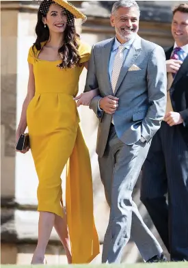  ??  ?? Golden glamour: Amal Clooney arm in arm with George