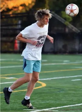  ?? CHRiS cHRiSTO pHOTOS / HeRALD STAFF ?? ON A ROLL: Newburypor­t’s Jack Fehlner heads the ball during practice on Wednesday, also seen at top right.