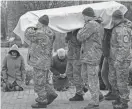  ?? VADIM GHIRDA/AP ?? Ukrainian soldiers carry the coffin of Volodymyr Hurieiev, a soldier killed in the Bakhmut area.