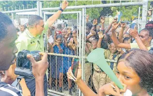  ?? PHOTO BY GARETH DAVIS SR ?? Prime Minister Andrew Holness greeting students of Buff Bay Primary during a tour of West Portland on Monday.