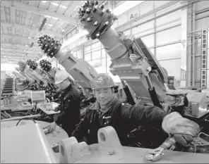  ?? ZHANG WENKUI / FOR CHINA DAILY ?? Employees of Sany Heavy Industry Co at a workshop in Shenyang, Liaoning province.