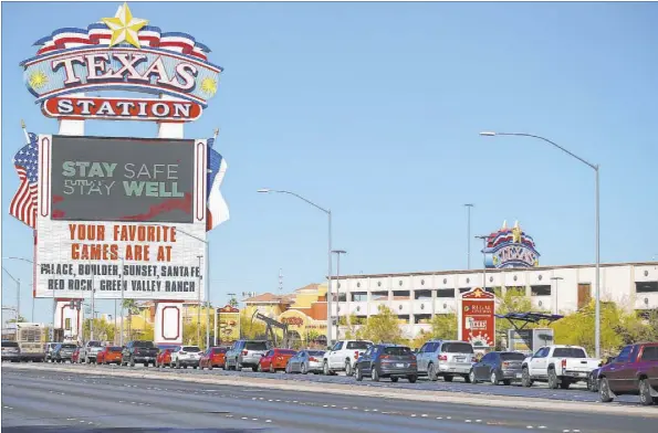  ?? Chase Stevens Las Vegas Review-Journal @csstevensp­hoto ?? People wait in line Saturday at the drive-thru COVID-19 testing site at Texas Station. At one point, the line of cars stretched for almost a mile.