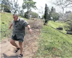  ?? African News Agency (ANA) ?? LUCIANO CATTANEO tries to walk along Stellawood Cemetery’s driveway, but is hindered by the discarded branches of trees cut by ethekwini Municipali­ty workers six months ago.