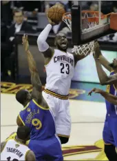  ??  ?? Cleveland Cavaliers forward LeBron James (23) shoots against the Golden State Warriors during the second half of Game 4 of basketball's NBA Finals on Friday in Cleveland. AP PHOTO
