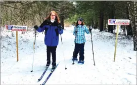  ?? Photo by Angela Cornelius ?? Pictured are Sharon Turano on cross-country skis and Kate Sager on snow shoes.