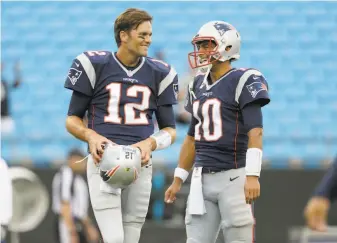  ?? Bob Leverone / Associated Press 2016 ?? ThenPatrio­ts Tom Brady and Jimmy Garoppolo laugh before a 2016 game at Carolina. Now Brady is a Buccaneer, Garoppolo a 49er, and the Patriots are 23 for the first time in 19 seasons.