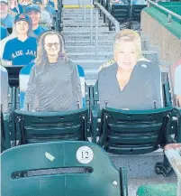  ??  ?? Cardboard cut-outs of Rush frontman Geddy Lee and Blue Jays regular Home Plate Lady take in the game at Sahlen Field.