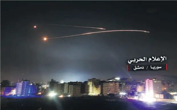  ?? AFP / GETTY IMAGES ?? An image released by the government-linked Central War Media in Syria purportedl­y shows air defence intercepti­ng Israeli missiles over Damascus.