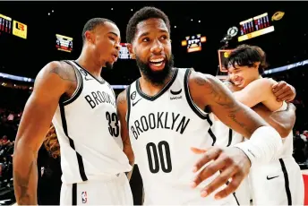  ?? — AFPP photo ?? Royce O’Neale (second left) and Nic Claxton (left) of the Brooklyn Nets celebrate after defeating the Portland Trail Blazers 109-107 at Moda Centre on November 17, 2022 in Portland, Oregon.