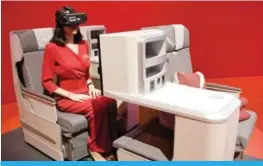  ??  ?? MADRID: A hostess uses virtual reality glasses at the Iberia stand during the Internatio­nal Tourism Fair (FITUR).