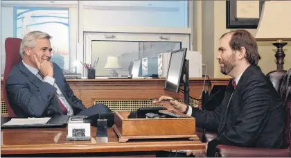  ?? JOE GIBBONS/THE TELEGRAM ?? Premier Dwight Balls speaks with Telegram reporter James Mcleod.