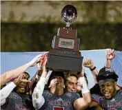  ?? MATT STRASEN / AP ?? The Miami RedHawks hold up their championsh­ip trophy after the team’s 27-14 win over North Texas in the Frisco Football Classic in December. Fans will get a look at the RedHawks’ bid to get back to a bowl game today in the Spring Showcase.