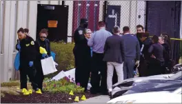  ?? MICHAEL CONROY – THE ASSOCIATED PRESS ?? Authoritie­s confer at the scene where multiple people were shot at the FedEx Ground facility late Thursday night.