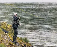  ?? PA ?? Fisherman on the bank of Ballysalla­gh Lower Reservoir near Craigantle­t