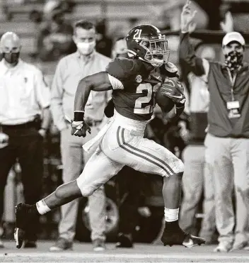  ?? Mickey Welsh / Associated Press ?? Alabama running back Jase McClellan scores a touchdown against Kentucky during the Crimson Tide’s 63-3 win over the Wildcats on Saturday. The Tide held on to their No. 1 spot in the AP Top 25 poll.