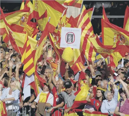  ??  ?? 0 Protesters wave Spanish and Catalan flags at a pro- unity demo in Barcelona following the declaratio­n of independen­ce