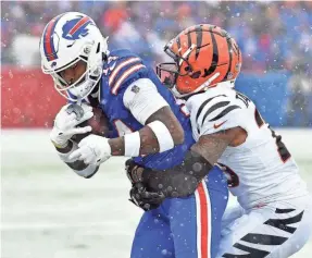  ?? MARK KONEZNY/USA TODAY SPORTS ?? Bills wide receiver Stefon Diggs is stopped by Bengals cornerback Cam Taylor-Britt.
