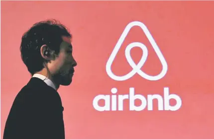  ??  ?? A man walks past a logo of Airbnb after a news conference in Tokyo, Japan. — Reuters photo