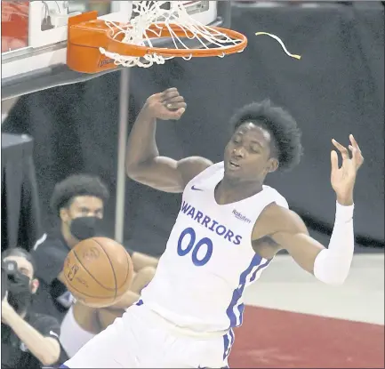  ?? ETHAN MILLER — GETTY IMAGES ?? Jonathan Kuminga, drafted seventh by the Warriors, dunks for two of his 16 points in Monday’s NBA Summer League game in Las Vegas.