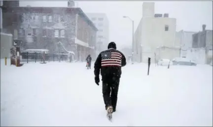  ?? MATT ROURKE — THE ASSOCIATED PRESS ?? A man pushes his way through a winter snowstorm in Atlantic City, N.J., Thursday.