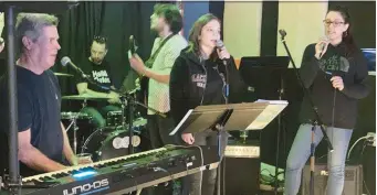  ?? TED SLOWIK/DAILY SOUTHTOWN ?? Vocalists Tim Placher, from left, Chloe Briese and Robyn Castle rehearse Sunday for “A Shamrockin’ Good Time with Tim Placher and Friends,” to be presented Friday at the Rialto Square Theatre in Joliet.