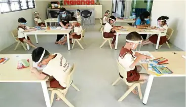  ??  ?? Keeping their distance: Children sitting at designated areas at Nalanda Kindergart­en in Taman setapak after it reopened with strict sOPs in place. — aZMaN GhaNI/The star