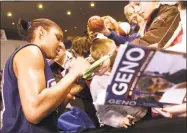  ?? Hearst Connecticu­t Media file photo ?? UConn forward Maya Moore signs autographs following practice at Bridgeport Arena at Harbor Yard in 2008.
