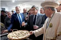  ?? Reuters ?? Francois Fillon (centre) and mayor of Meaux Jean-Francois Cope (left), taste cheese during a meeting with Brie cheese producers at the tourist office in Meaux, near Paris, on Monday. —