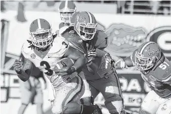  ?? JOHN KELLEY/GEORGIA PHOTO ?? Georgia tailback Todd Gurley had 100 rushing yards and 87 receiving yards during the 23-20 win over Florida in 2013, but the Gators have won the past two meetings by the combined count of 65-23 and are 7-point favorites this week.