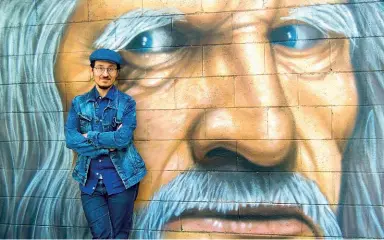  ??  ?? Opera Il cantautore milanese Marco di Noia, 39 anni, davanti a un murales di Alessio Arkham dedicato a Leonardo