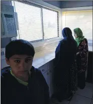  ??  ?? The wife, daughter and son of Abdul stand in the kitchen of the house the family has been provided to stay in.
