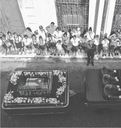  ?? RONALDO SCHEMIDT / AFP / GETTY IMAGES ?? The urn containing the ashes of Cuban leader Fidel Castro is driven through Matanzas, Cuba, on Wednesday beginning a four-day journey across the island. Castro died last Friday at age 90.