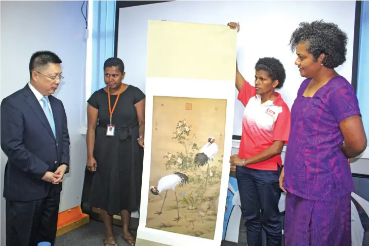  ??  ?? Standing from left: Chinese Ambassador to Fiji Qian Bo, Fiji Sun Managing Editor Business Maraia Vula, Deputy-Managing Editor Business Lusiana Tuimaisala, and Managing Editor Rosi Doviverata. All the three editors have been and seen China. Mr Qian gifted the Fiji Sun a copy of a classic Chinese silk painting by artist Lang Shiyuan called: “Duo Red-crowned Cranes Amid Blossoming China Rose.”