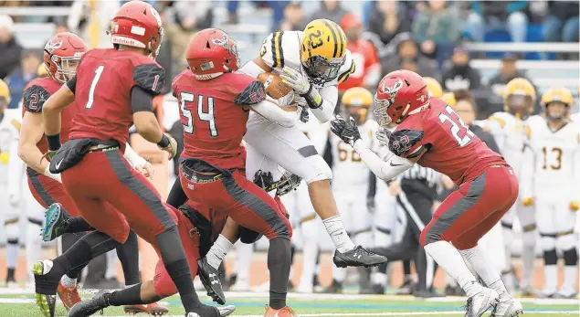  ?? DAVID GARRETT/SPECIAL TO THE MORNING CALL ?? Freedom's Jalen Stewart tries to jump over defenders and is stopped by St. Joe's Jeremiah Trotter Jr. (54) as Freedom High School plays St. Joseph's Prep in a PIAA 6A quarterfin­al game Saturday afternoon at Northeast High School in Philadelph­ia.