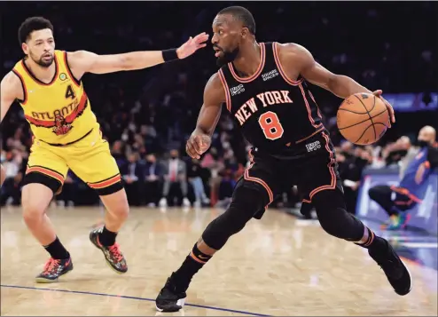  ?? Adam Hunger / Associated Press ?? Knicks guard Kemba Walker (8) drives against Hawks guard Skylar Mays during the second half of Saturday’s game.