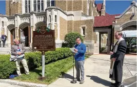  ?? ED RICHTER / STAFF ?? William Kennedy, of the Ohio History Connection (center), reads the text of the newly installed historical marker commemorat­ing the bicentenni­al of the First Baptist Church of Dayton after services Sunday. Lead pastor Dr. Kent Berghuis (right) said the church “has long been a beacon of progressiv­e ministry.”