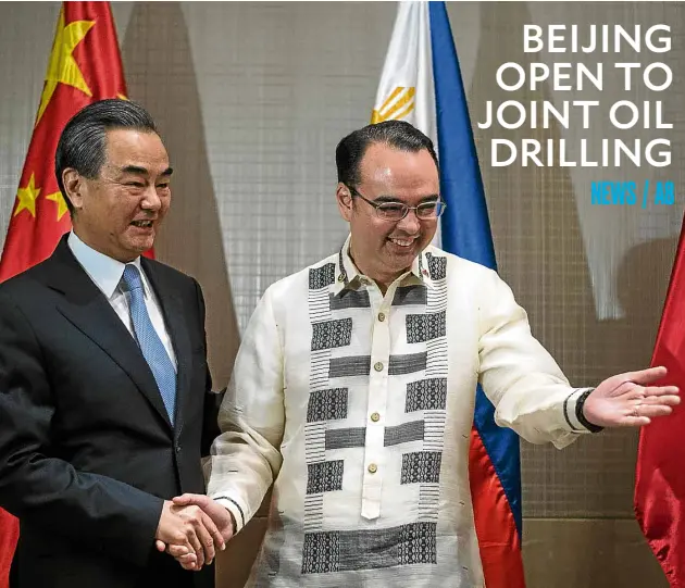  ?? AFP ?? WIN-WIN DEAL Chinese Foreign Minister Wang Yi and Foreign Secretary Alan Peter Cayetano support joint venture in the South China Sea.—