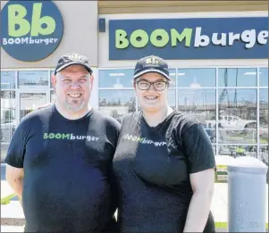  ?? MITCH MACDONALD/THE GUARDIAN ?? Bedford Boom Burger manager Victoria Comeau, right, and assistant manager Dale Whynacht stand with pride outside the establishm­ent. The unique restaurant showcases its P.E.I. roots, with posters inside promoting Island potatoes, raspberry cordial and...