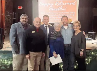  ?? / Amy Jackson ?? On Dec. 4, friends, family and dignitarie­s people gathered at the Ringgold De-pot to wish Catoosa County Chamber of Commerce President and CEO Martha Eaker the best as she retired from her 12-year position. From left: Catoosa County commission­ers Jeff Long, Jim Cutler and Ray Johnson; Martha Eaker; Catoosa County Commission Chair Steven Henry; Uniktings owner and Chamber member Cindie Robinson Patty, who presented Eaker with the Tiffany bracelet the Chamber bought for her.