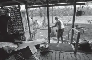  ?? MATHEW MCCARTHY, RECORD STAFF ?? Gloria Houle of Kitchener leaves her trailer after collecting a few items at the Pioneer Sportsman Club trailer park on Monday. The trailer was heavily damaged by flooding.