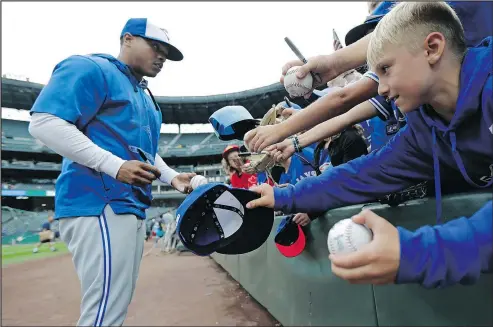  ?? — AP ?? A young fan waits for an autograph from Jays’ Marcus Stroman before the team’s game against the Mariners in Seattle last night.