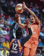  ?? SEAN D. ELLIOT/ THE DAY ?? Connecticu­t Sun guard Jasmine Thomas, right, shoots over Phoenix Mercury guard Briann January in the first half of a WNBA game Friday, July 13, at Mohegan Sun Arena. The Sun begin the second half of their season tonight at Mohegan Sun Arena, meeting the New York Liberty.