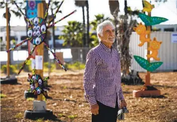  ?? NANCEE E. LEWIS PHOTOS ?? Longtime City Heights resident Jim Bliesner curated the open-air art installati­on at the corner of University Avenue and Interstate 15. His goal is to connect neighborho­od residents to art.