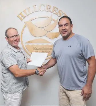  ?? Picture: GLENN HAMPSON ?? New Zealand head coach Pero Cameron (right) signs his Hillcrest deal with executive head of the college, Jeff Davis, yesterday.