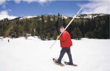  ?? Michael Macor / The Chronicle ?? Frank Gehrke of the Water Resources Department heads out to take a survey that found snowpack around half of average.