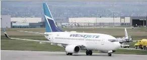  ?? JEFF MCINTOSH / THE CANADIAN PRESS ?? WestJet pilots are in a strike position, prompting rival Air Canada to expand capacity on key routes.