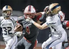  ?? Pittsburgh Post-Gazette ?? Avonworth's Jax Miller stiff-arms McGuffey's C.J. Cole earlier this season. Miller rushed for 291 yards last Saturday in the WPIAL championsh­ip.