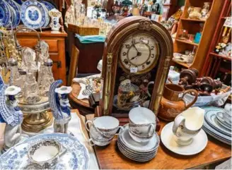  ?? PATRICIA HARRIS FOR THE BOSTON GLOBE ?? Clocks are ubiquitous amid the otherwise eclectic array of goods at Grand Army Antiques.