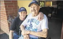  ?? Ricardo DeAratanha Los Angeles Times ?? JIM BALLARD , with grandson John McCoy, built bridges during World War II, now thinks Dodgers are burning bridges with fans.